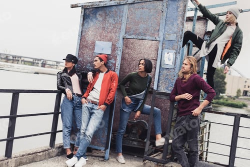 Preview: group of stylish young people at river port looking at side