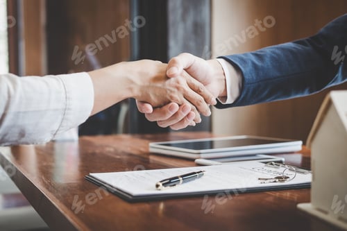Preview: Real estate agent and customers shaking hands together celebrating finished contract after about