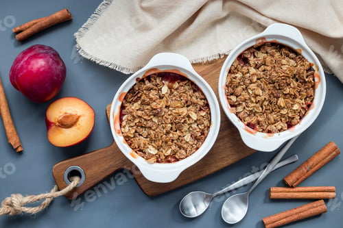 Preview: Plum crumble pie or plum crisp with oats and spices, in baking d