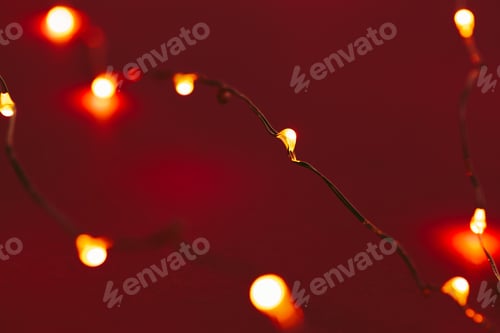 Preview: Red background with illuminated lights of garland