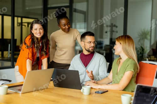 Preview: Young multiethnic startup team working in the modern office