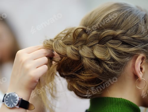 Preview: Young woman/bride getting her hair done before wedding or party