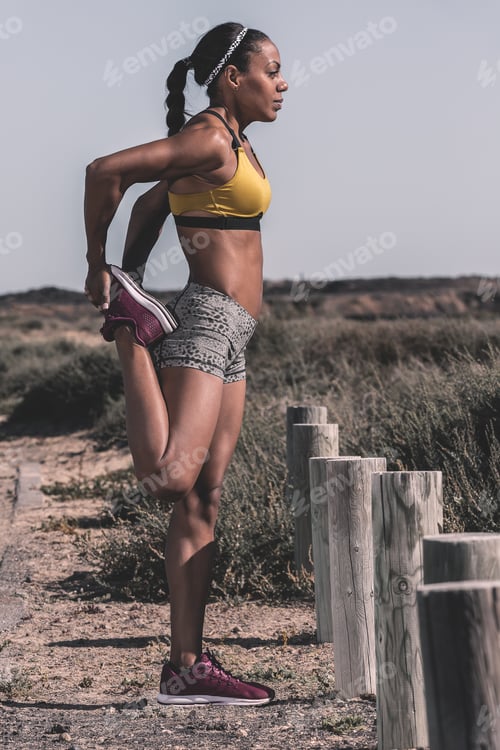Preview: Sportive black woman training on roadside