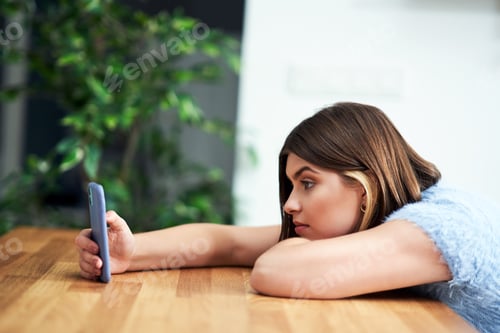 Preview: Teenage girl texting at home