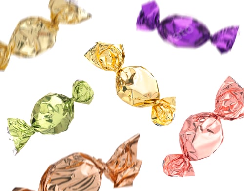 Preview: Candies in bright wrappers falling on white background