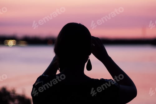 Preview: Silhouette of a girl on the sunset background