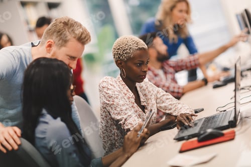 Preview: Programmers cooperating at information technology company