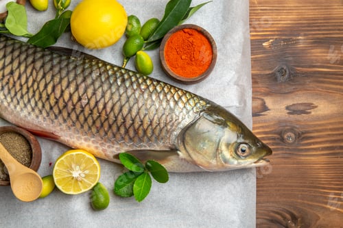 Preview: top view fresh fish with lemons on a brown desk food seafood dish ocean