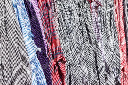 Preview: Traditional Keffiyeh or kefia hanging on hangers on bazaar in Egypt