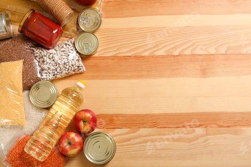 Preview: Many different products and space for text on wooden background, flat lay. Food donation