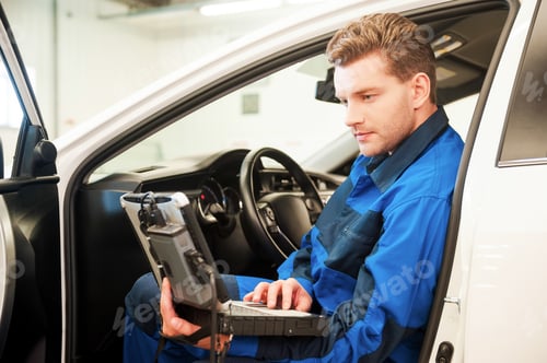 Preview: Examining car with special computer.