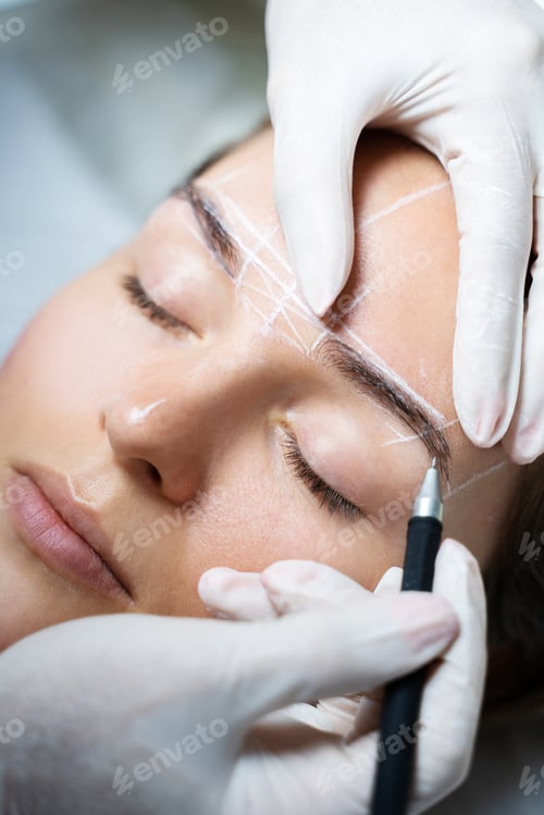 Preview: Woman during professional eyebrow mapping procedure
