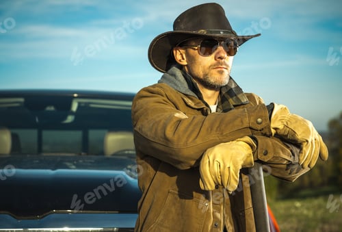 Preview: Caucasian Rancher Wearing Cowboy Hat and Sunglasses