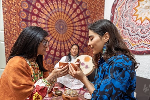 Preview: Women holding cups during organic cocoa ceremony for alternative medicine