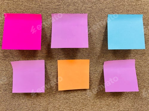 Preview: Colorful blank sticky notes on textured office divider.