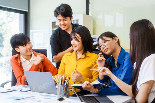 Preview: Five young Asian professionals collaborate at a startup meeting, analyzing finances, strategy
