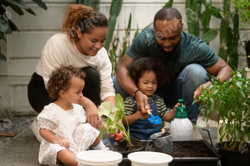 Preview: Happy African American family enjoying gardening at home