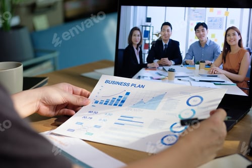 Preview: asisn woman video conference busienss meeting with colleage online with laptop at home