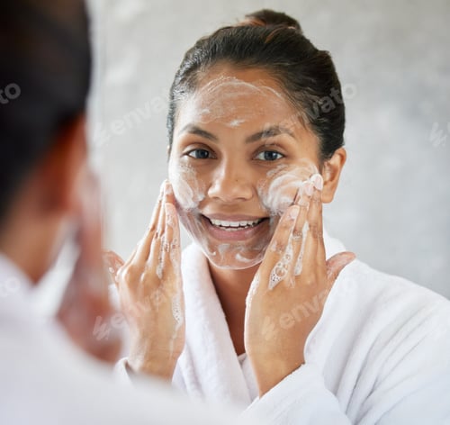 Preview: Makeup is ART, Beauty is SPIRIT. Shot of young woman using with facial moisturiser.