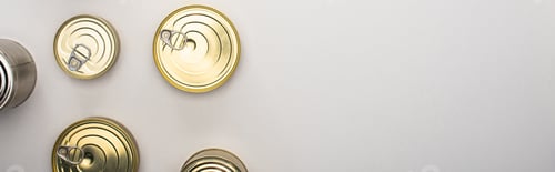 Preview: top view of cans with canned food on white background, food donation concept