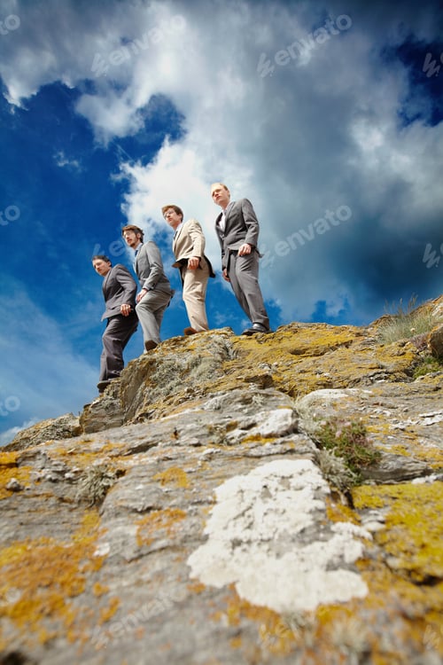 Preview: Businessmen peering over cliff edge