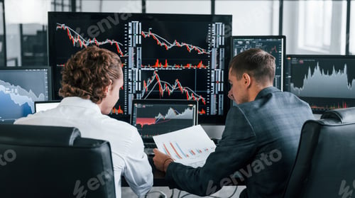 Preview: Conception of teamwork. Team of stockbrokers works in modern office with many display screens