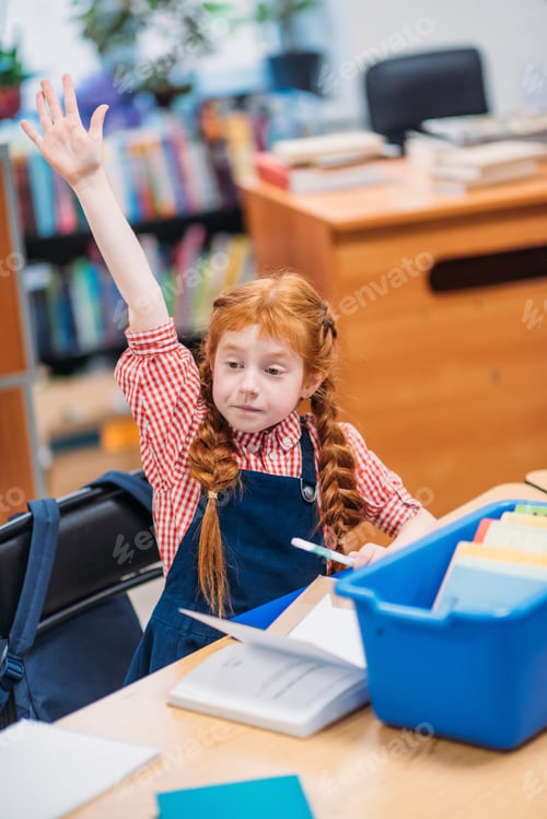 Preview: adorable redhead schoolgirl raising hand