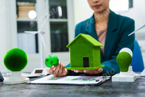 Preview: An Asian businesswoman sits at her desk, discussing clean energy solutions their impact on homes