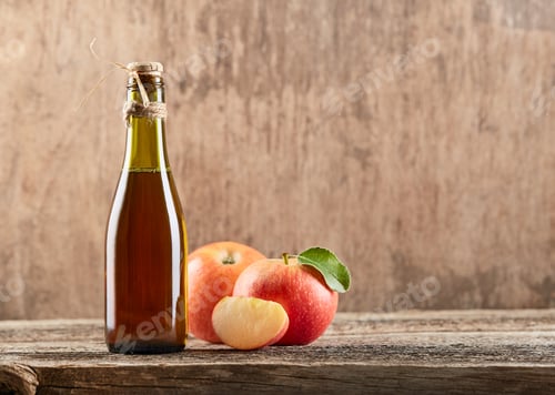Preview: Apple vinegar with apple fruit on old wooden background. Fermented product
