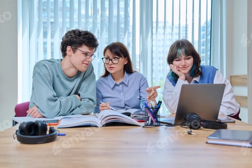 Preview: College students with teacher sitting at desk in classroom studying languages, sciences