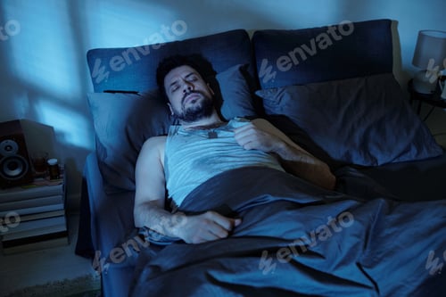 Preview: Man Lying Awake in Bed Experiencing Family Problems