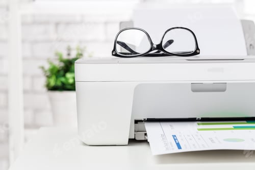 Preview: Printer with glasses and documents on a desk in a bright office environment during daytime
