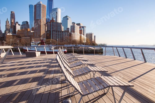 Preview: Beach beds on wooden boardwalk with seating overlooking a body of water