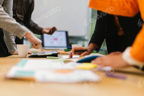 Preview: Business people working together using digital tablet and documents during meeting