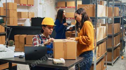 Preview: Team of young workers analyzing stack of products