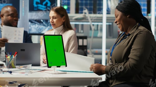 Preview: Managers in office reviewing solar technology reports on isolated screen tablet