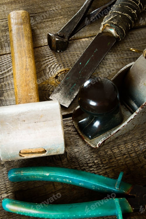 Preview: Many old working tools on a wooden background.