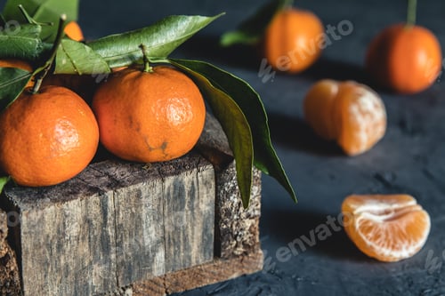 Preview: Box with tasty juicy tangerines in wood box on dark background with copy space