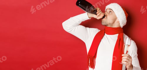 Preview: Concept of winter holidays, christmas and lifestyle. Man getting drunk on new year party, drinking