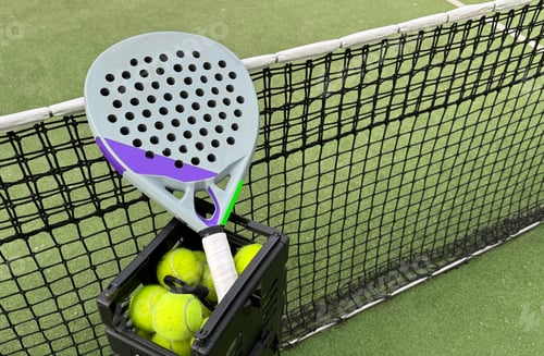 Preview: Background of padel racket and ball on artificial grass floor in outdoor court. Top view.
