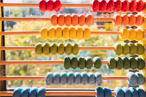 Preview: Detail of the colored beads of a wooden abacus, elementary educational material.
