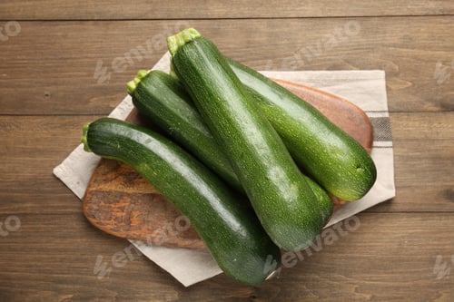 Preview: Fresh ripe zucchinis on wooden table, top view