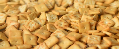 Preview: A lot of small cookies are square shaped. A pattern of a yellow salt cracker. Background