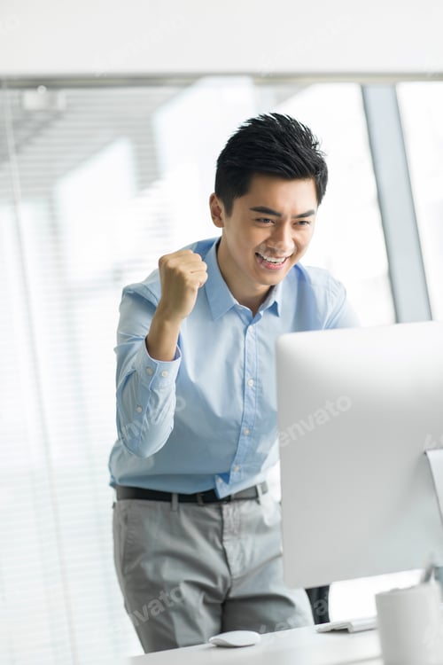 Preview: Young businessman using computer in office
