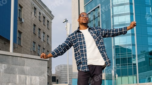 Preview: Stylish happy cheerful afro american guy african man singing song sings enjoying music dancing