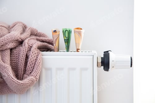 Preview: Radiator with thermostat and euro money banknotes.
