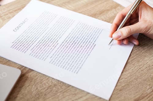 Preview: Man signs a contract at a desk in a company office