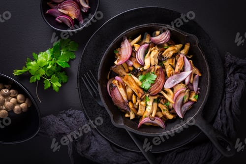 Preview: Fried mushrooms with onions and herbs on dark background