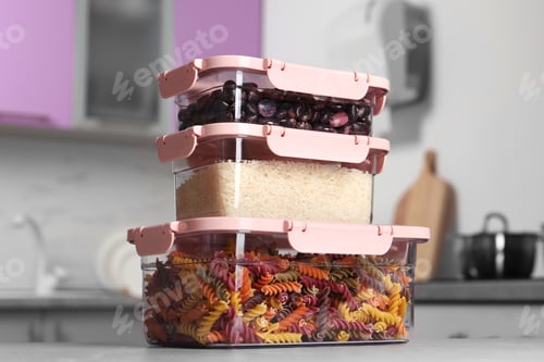 Preview: Stacked boxes with different food on table in kitchen