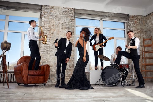 Preview: Repetition of multi ethnic jazz band in loft. Bass guitar player, electric guitar player